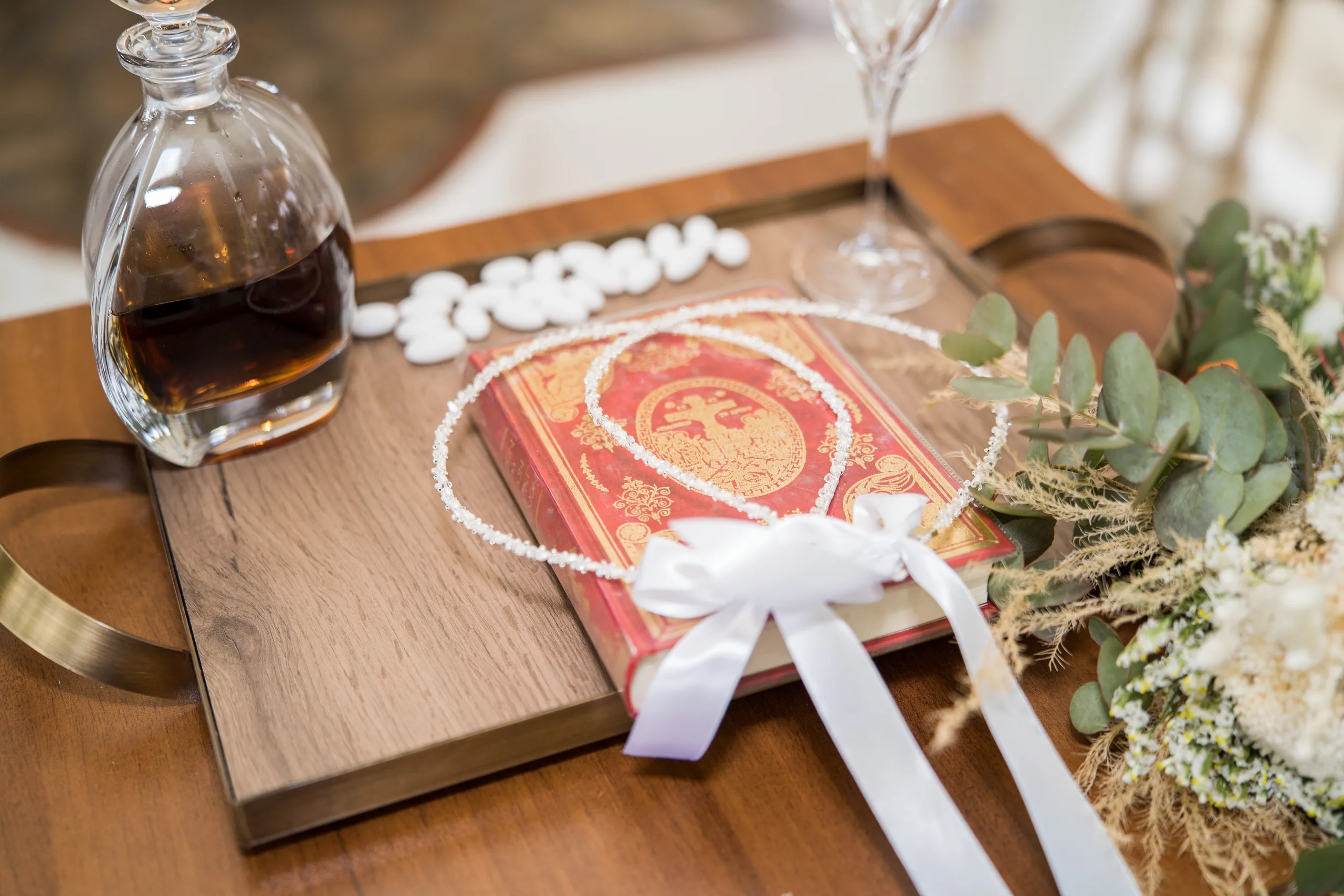 The baptism tray with the oil, the Gospel book and white ribbons