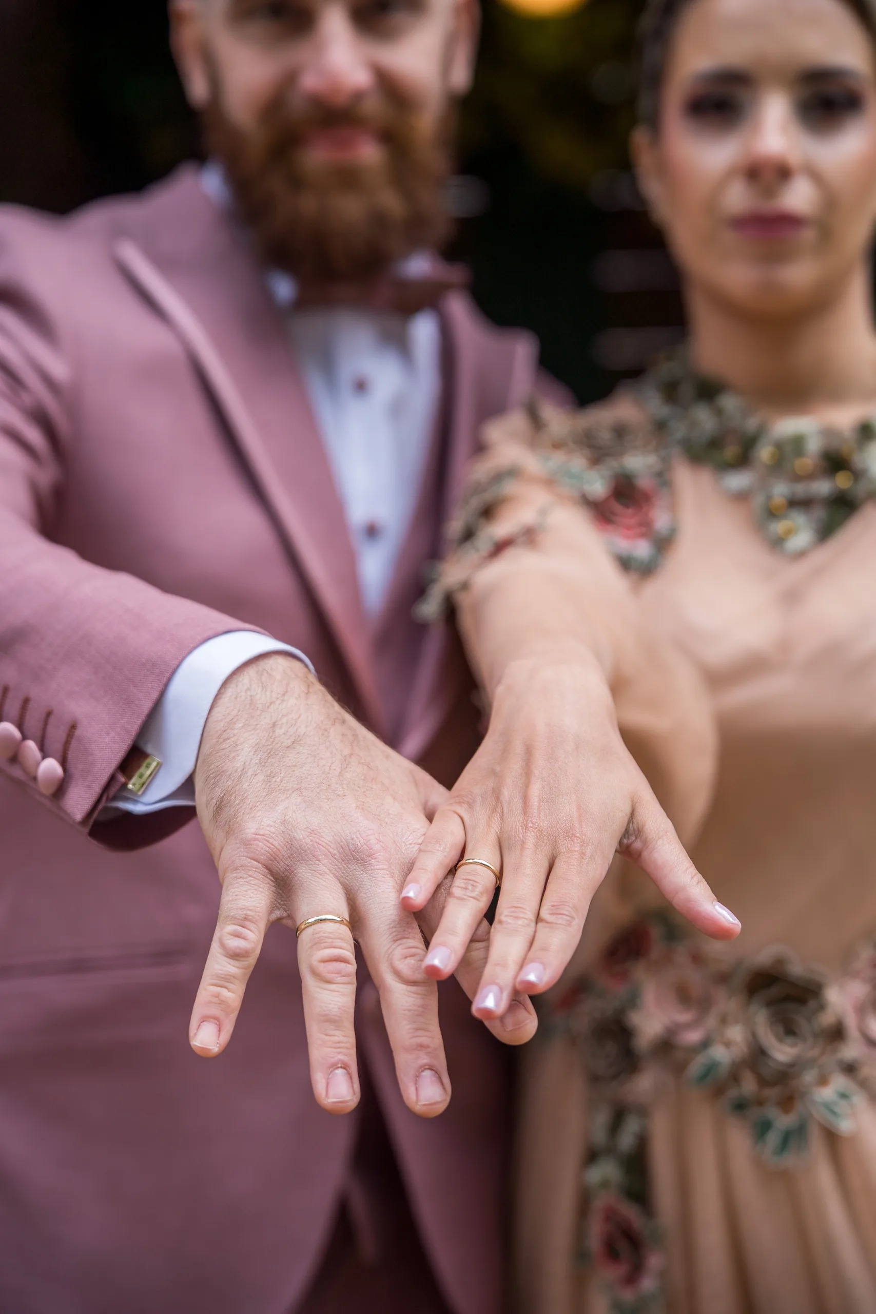 The couple's hands showing their wedding rings