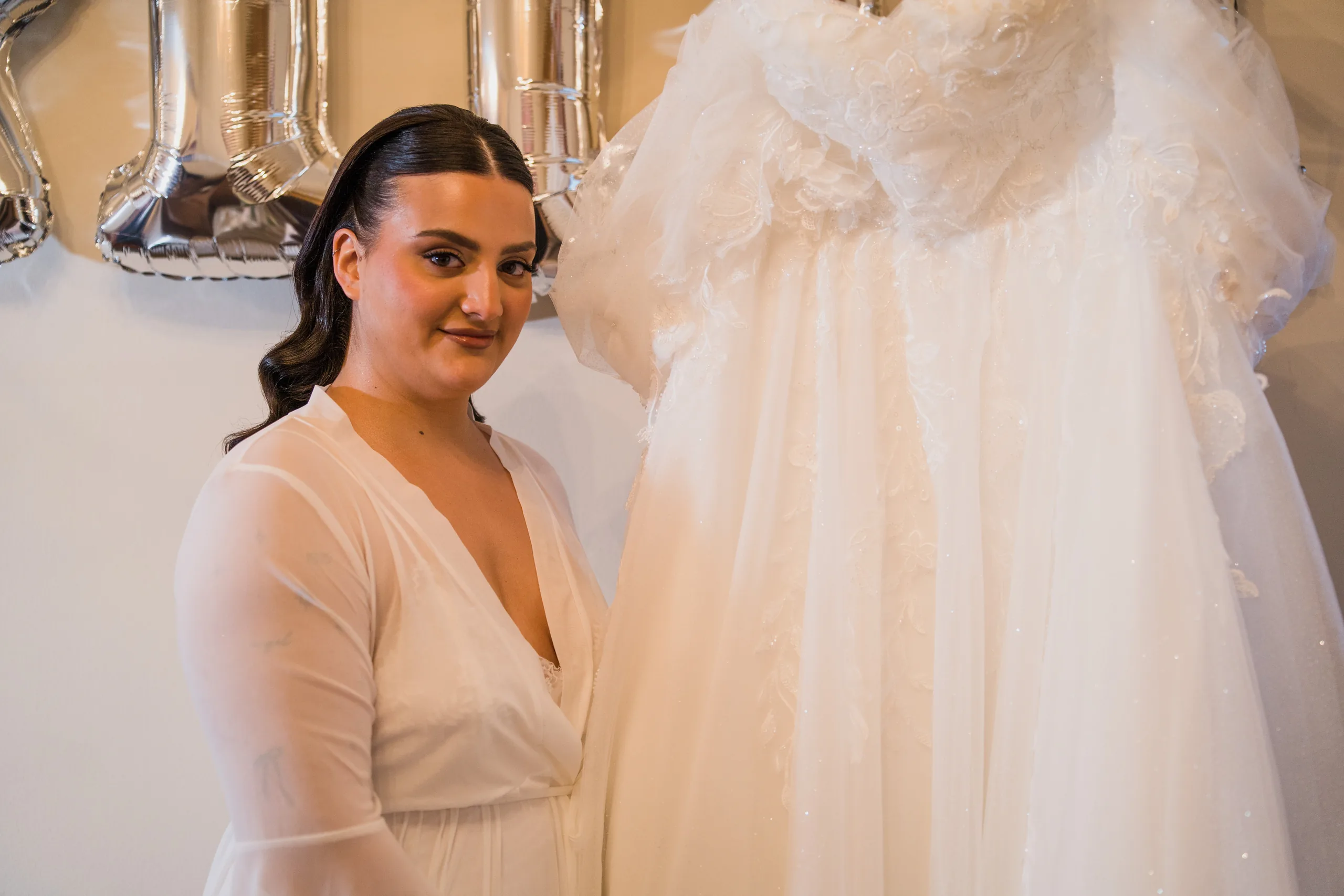 The bride beside her wedding dress