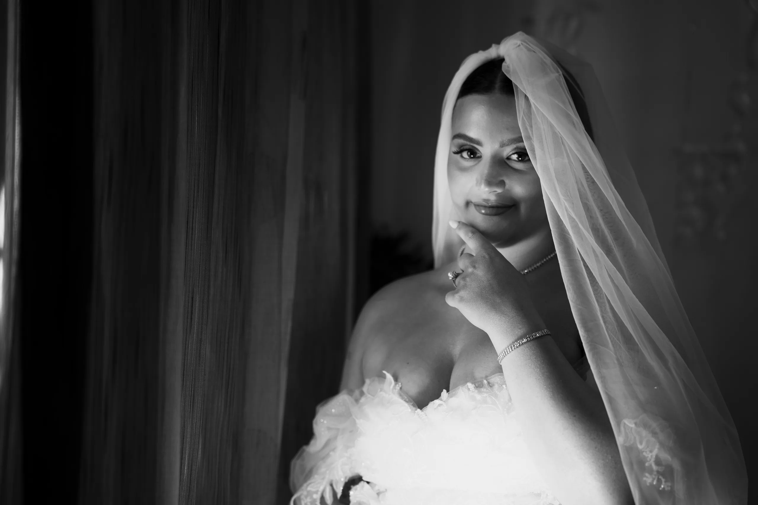Black-and-white portrait of the bride in her veil