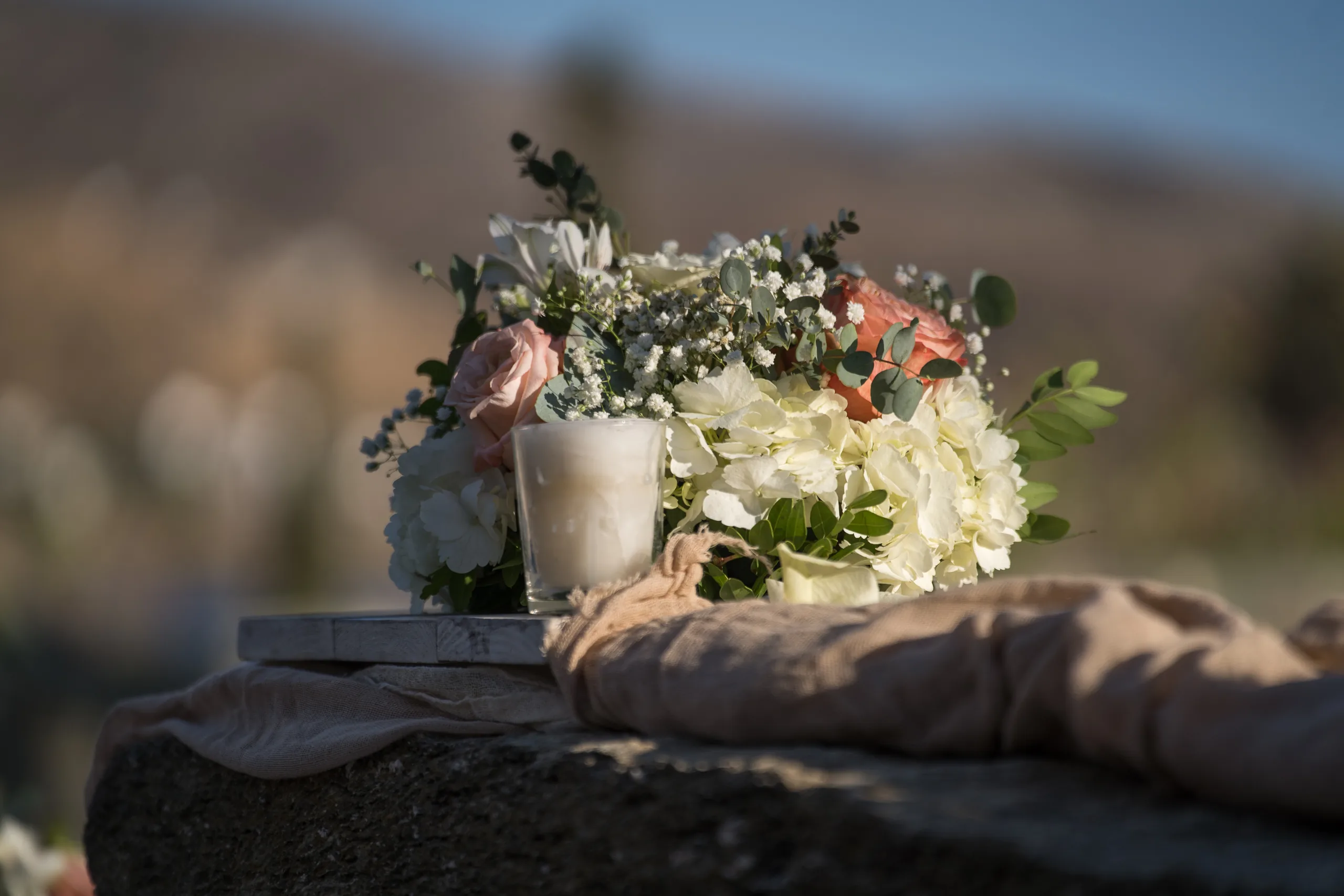 The bridal bouquet resting on a stone wall