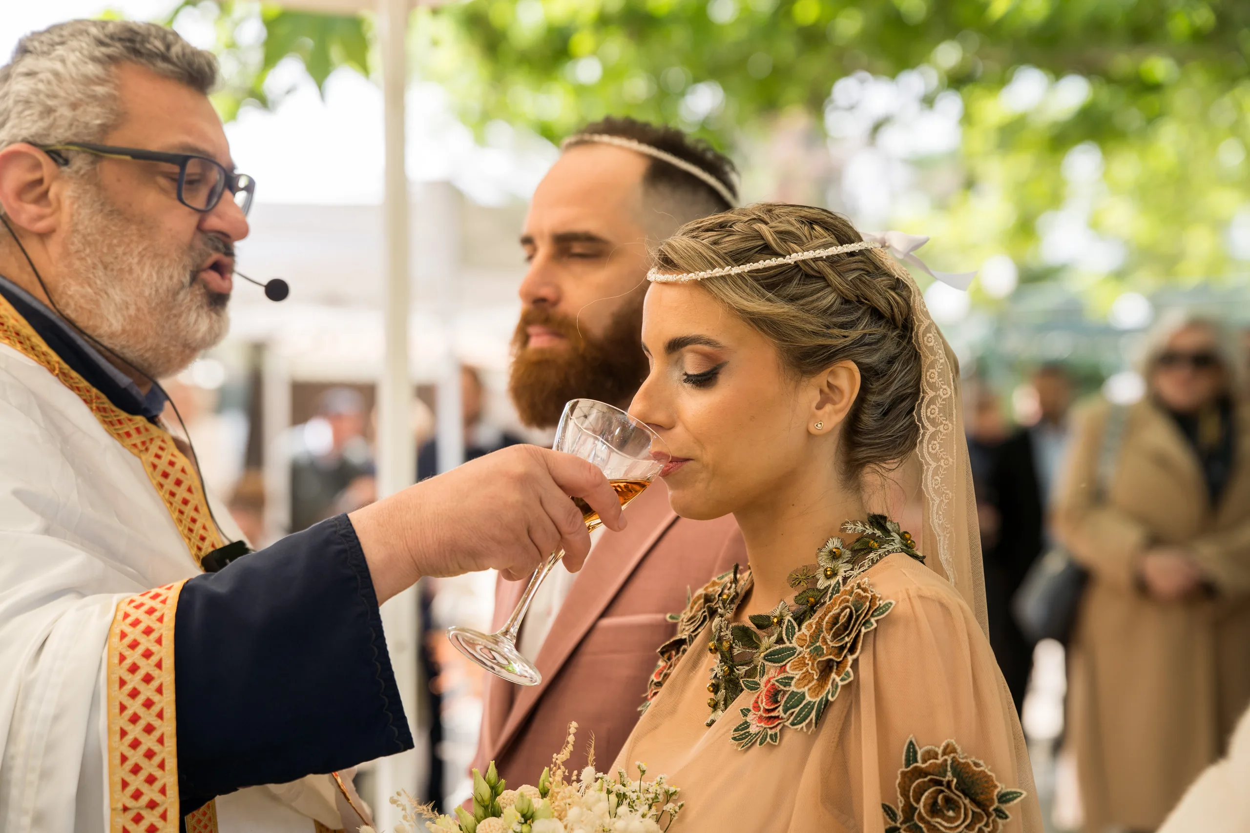 The bride drinks from the common cup held by the priest