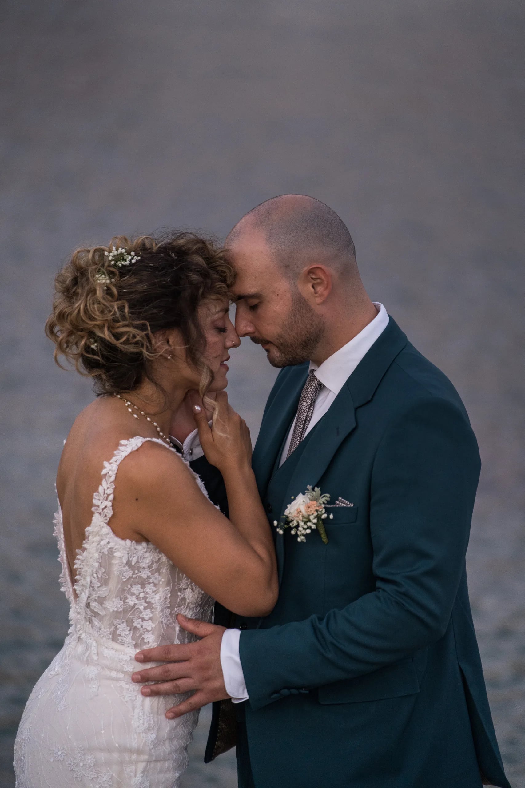 The couple forehead to forehead at dusk