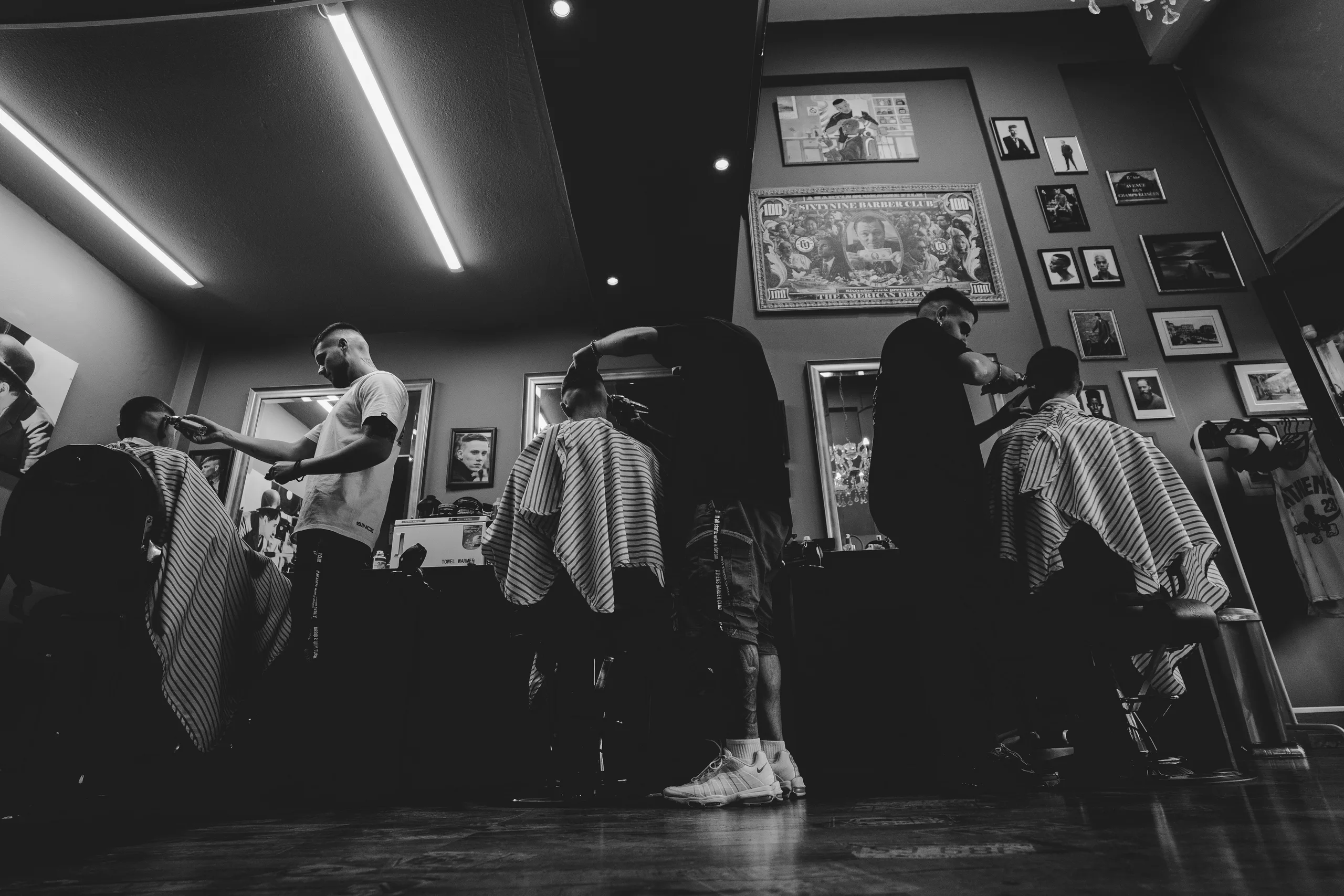 Black and white view of a busy barber shop